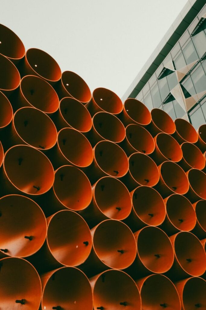 Abstract view of a modern architectural facade in Dubai with vibrant orange tubes.